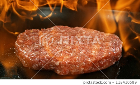 Hamburger Minced Raw Beef Steak on Grill with Flames. Hamburger Minced Raw Beef Steak on Grill with Flames. 118410599