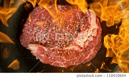 Raw Beef Steak on Frying Pan with Flames. Raw Beef Steak on Frying Pan with Flames. 118410604
