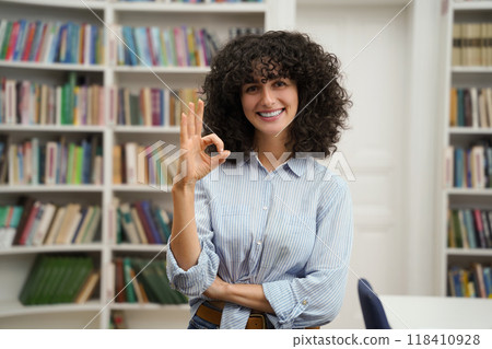 Cute dark-haired young woman looking happy and excited Cute dark-haired young woman looking happy and excited 118410928