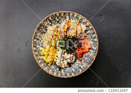 Delicious poke bowl with fresh salmon, mango, rice, seaweed - perfect for healthy and colorful meals 118411047