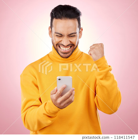 Winner, man and phone for success, yes and celebration of online news, social media or gaming results. Excited, mobile games and person reading notification or website bonus on pink studio background Winner, man and phone for success, yes and celebration of online news, social media or gaming results. Excited, mobile games and person reading notification or website bonus on pink studio background 118411547