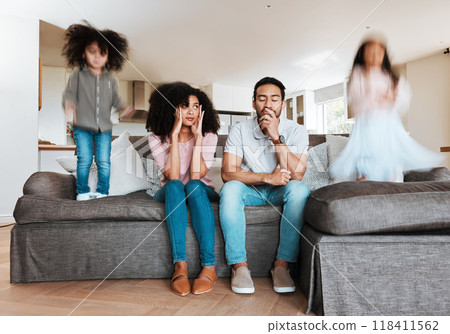 Children jumping with stressed parents on the sofa to relax in the living room of their house. Upset, burnout and excited kids playing with blur motion on couch with tired exhausted mother and father Children jumping with stressed parents on the sofa to relax in the living room of their house. Upset, burnout and excited kids playing with blur motion on couch with tired exhausted mother and father 118411562