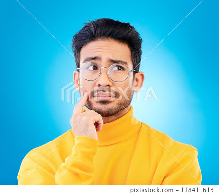 Thinking, face or studio man planning solution, problem solving inspiration or doubt idea, question or confused. Mindset, wonder or person brainstorming options, decision or choice on blue background Thinking, face or studio man planning solution, problem solving inspiration or doubt idea, question or confused. Mindset, wonder or person brainstorming options, decision or choice on blue background 118411613