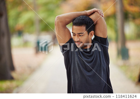 Asian man, stretching arms and fitness in park getting ready for running, workout or exercise outdoors. Male person, athlete or runner in warm up arm stretch, training or run for exercising in nature 118411624