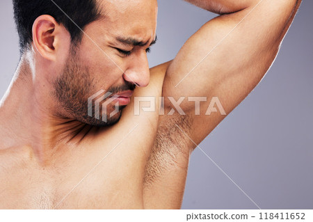 Armpit, stink and man with body odor in studio isolated on a white background for deodorant, cleaning and skincare cosmetic. Underarm, bad smell and model with hyperhidrosis, sweating or poor hygiene Armpit, stink and man with body odor in studio isolated on a white background for deodorant, cleaning and skincare cosmetic. Underarm, bad smell and model with hyperhidrosis, sweating or poor hygiene 118411652