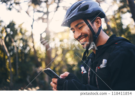 Cycling, phone and smile with man in nature for search, networking and connection. Relax, happy and social media with male cyclists in forest park for training, sports and internet browsing Cycling, phone and smile with man in nature for search, networking and connection. Relax, happy and social media with male cyclists in forest park for training, sports and internet browsing 118411854