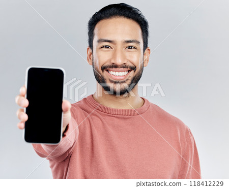 Asian man, portrait smile and phone mockup for advertising or marketing against a white studio background. Happy male smiling with smartphone screen or display for mobile app advertisement or brand Asian man, portrait smile and phone mockup for advertising or marketing against a white studio background. Happy male smiling with smartphone screen or display for mobile app advertisement or brand 118412229
