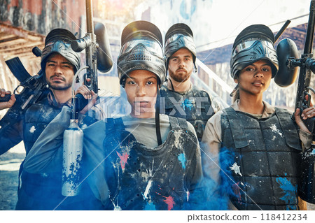 Paintball, focus and portrait of team or people ready for a battle and teamwork or collaboration together. Serious, sports and army on a mission on the battlefield with guns for outdoor competition 118412234