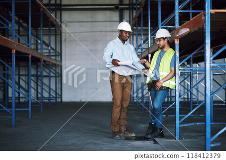 Business people, blueprint and meeting in construction, team planning or ideas for building strategy on site. Architect men in teamwork discussion, floor plan or documents for industrial architecture Business people, blueprint and meeting in construction, team planning or ideas for building strategy on site. Architect men in teamwork discussion, floor plan or documents for industrial architecture 118412379