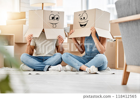 Funny, couple moving and boxes on head with faces, smile or emoji drawing on cardboard and new house, property or real estate. People, comic and box on body with happiness, crazy or joke in home 118412565