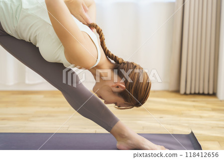 A young woman showing poses in an online yoga salon broadcast A young woman showing poses in an online yoga salon broadcast 118412656