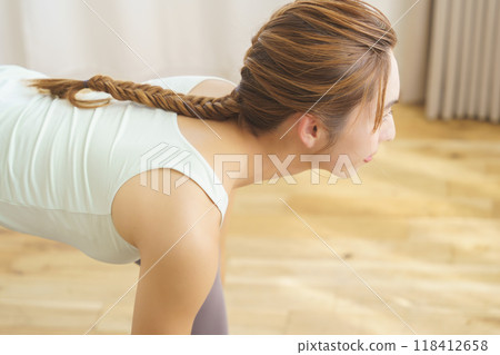A young woman showing poses in an online yoga salon broadcast 118412658