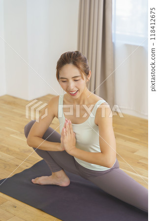 年輕女子在線上瑜珈沙龍分發中展示姿勢 年輕女子在線上瑜珈沙龍分發中展示姿勢 118412675