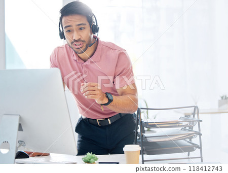Asian man, call center and consulting with headphones on computer for customer service or desktop support at office. Male consultant agent talking with headset on PC for online telemarketing advice Asian man, call center and consulting with headphones on computer for customer service or desktop support at office. Male consultant agent talking with headset on PC for online telemarketing advice 118412743