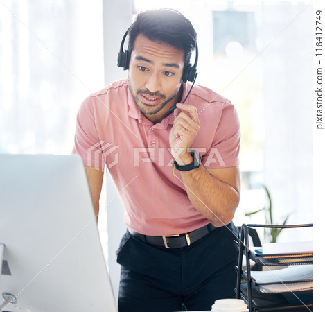 Serious asian man, call center and computer in customer service or desktop support at office desk. Male consultant agent standing by PC in telemarketing advice or insurance with headset at workplace Serious asian man, call center and computer in customer service or desktop support at office desk. Male consultant agent standing by PC in telemarketing advice or insurance with headset at workplace 118412749
