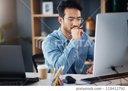 Serious, business man and thinking on computer in office, internet research and website. Focused male employee, desktop and solution of ideas, planning decision and review strategy, project or vision 118412792