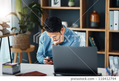 Bored, phone and businessman in his office networking on social media, mobile app or the internet. Technology, professional and tired male employee browsing on a website with a cellphone in workplace 118412794
