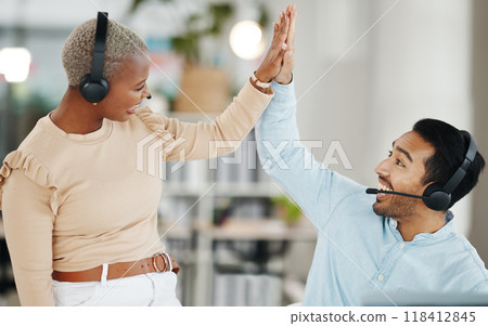 Asian man, call center and team celebration with high five for winning, bonus or sale in telemarketing at office. Happy and excited male consultant touching hand of colleague for win or promotion 118412845