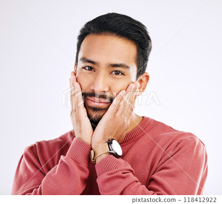 Portrait, shy and in love with a man in studio isolated on a white background while touching his cheeks. Face, coy and cute with a handsome young indian male feeling special on valentines day Portrait, shy and in love with a man in studio isolated on a white background while touching his cheeks. Face, coy and cute with a handsome young indian male feeling special on valentines day 118412922