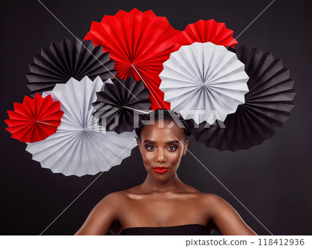 Face, makeup and black woman with origami fans in studio isolated on a dark background. Serious portrait, beauty cosmetics and skincare of female model with traditional Japanese paper art for culture 118412936