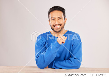 Smile, table and portrait of a man happy to relax on a desk feeling confident isolated in a studio white background. Resting, calm and young male person looking handsome, friendly and with style Smile, table and portrait of a man happy to relax on a desk feeling confident isolated in a studio white background. Resting, calm and young male person looking handsome, friendly and with style 118412995