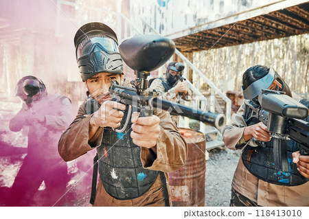 Teamwork, shooting and paintball with man in game for playground, war and gaming. Challenge, mission and soldier with people and smoke in battlefield arena for target, gun and warrior training 118413010