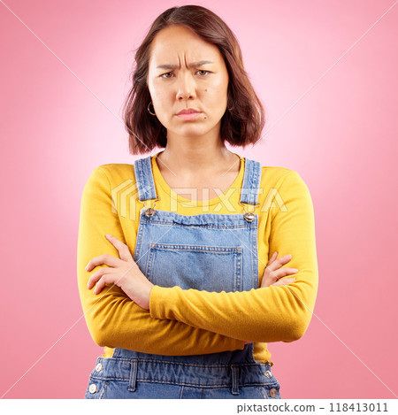 Portrait, frown and angry asian woman with arms crossed in studio and defensive body language on pink background. Wtf, face and frustrated Japanese female disappointed by news, fail or mood isolated Portrait, frown and angry asian woman with arms crossed in studio and defensive body language on pink background. Wtf, face and frustrated Japanese female disappointed by news, fail or mood isolated 118413011