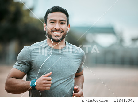 Fitness, portrait and man running with earphones for music, radio or sport podcast for motivation. Sports, exercise and male athlete runner doing outdoor cardio workout for race or marathon training. Fitness, portrait and man running with earphones for music, radio or sport podcast for motivation. Sports, exercise and male athlete runner doing outdoor cardio workout for race or marathon training. 118413043