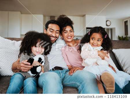 Portrait of mom, dad and kids on sofa, watching tv and happy family bonding together in living room. Smile, happiness and parents relax with children on couch, streaming television show or movies. 118413109