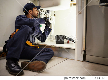 Plumbing, handyman and maintenance with man in kitchen for repair, industrial and inspection. Pipes, tools and safety with male plumber fixing sink for home improvement, drainage and water system 118413166