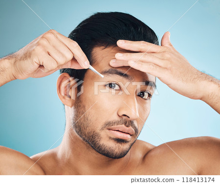 Man, face and eyebrow tweezers, beauty and skin, hair removal and cosmetics on blue background. Grooming, hygiene and male model, portrait and wellness with treatment, tools and self care in studio 118413174