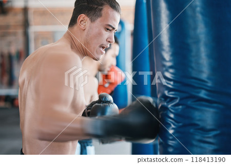 Sports, boxing and man with punching bag in gym for training, cardio workout and exercise. Fitness, body builder and male athlete with equipment for boxer competition, practice and mma performance Sports, boxing and man with punching bag in gym for training, cardio workout and exercise. Fitness, body builder and male athlete with equipment for boxer competition, practice and mma performance 118413190