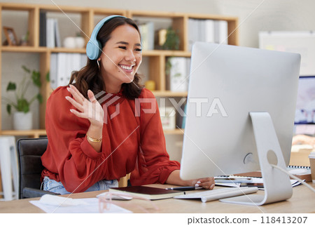 Headphones, computer and woman video call, webinar or virtual meeting, talking and online networking in business office. Happy Asian person wave hello on her desktop pc in client chat at tech company 118413207