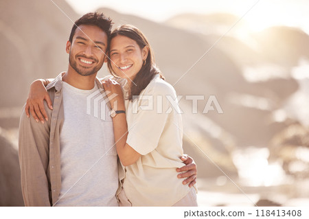 Portrait, couple and holiday with hug at ocean with happiness in the summer on the weekend. Face, smile and man with woman at the beach for travel with the sunshine for bond together on a trip. 118413408