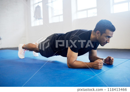 Sports, plank and fitness with man in gym for strong, workout and muscle. Exercise, power and health with male athlete and training on floor for wellness, abdominal challenge and balance Sports, plank and fitness with man in gym for strong, workout and muscle. Exercise, power and health with male athlete and training on floor for wellness, abdominal challenge and balance 118413466
