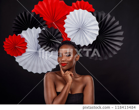 Beauty, portrait and black woman with origami fans in studio isolated on a dark background. Face, makeup cosmetics and skincare of female model with traditional Japanese paper art for culture hat. Beauty, portrait and black woman with origami fans in studio isolated on a dark background. Face, makeup cosmetics and skincare of female model with traditional Japanese paper art for culture hat. 118413484