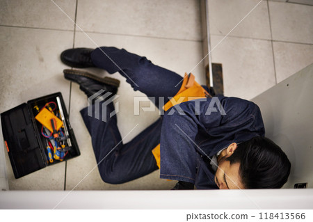 Plumbing, repair and maintenance with man in kitchen for man, industrial and inspection from above. Pipes, tools and safety with plumber fixing sink for home improvement, drainage and water system 118413566