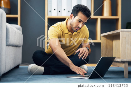 Remote work, typing and an Asian man with a laptop on the floor for entrepreneurship and freelancing. Serious, contact and an entrepreneur working on a computer, reading communication and an email 118413733