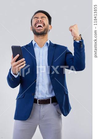 Winner, excited and phone with man in studio for good news, success and bonus. Pride, yes and celebration with male and cheering isolated on gray background for achievement, pride and job promotion 118413855