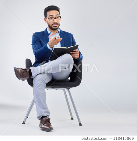 Questions, human resources and businessman with notebook for interview process in studio on grey background. Recruiter, asian male and recruitment process, negotiation and onboarding discussion 118413869