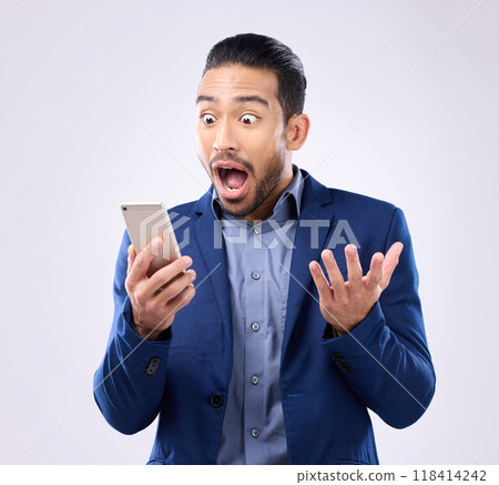 Business man, phone and wow for success in studio for winning, deal or bonus notification. Excited male model isolated on gray background with smartphone mobile app, internet competition or surprise Business man, phone and wow for success in studio for winning, deal or bonus notification. Excited male model isolated on gray background with smartphone mobile app, internet competition or surprise 118414242