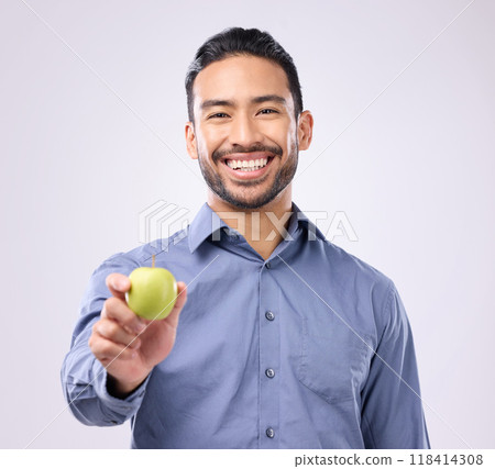 Apple, portrait and man happy with fruit for weight loss diet, studio healthcare or body detox. Wellness food, nutritionist lifestyle person and male vegan giving product isolated on gray background 118414308