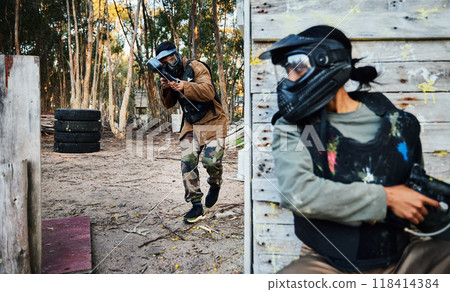 Paintball, sports and man with gun for battle, game or competition outdoors on field. War fight, military army and male soldier with weapon on shooting range while hiding from opponent for exercise. 118414384