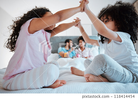 Happy, playful and relax with family in bedroom for morning, love and care. Happiness, support and free time with parents and children in bed at home for wake up, bonding and peace together 118414454