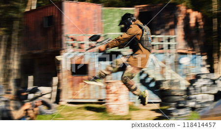 Paintball, man jump and aim gun at target, military tactics at shooting range and war game for sports outdoor. Soldier with weapon on battlefield, action and camouflage, motion blur and adventure 118414457