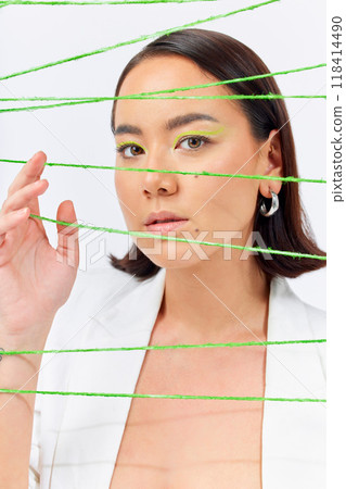 Creative, fashion and string with portrait of woman in studio for makeup, art and cosmetics. Abstract, cotton and texture with face of asian model on white background for designer, trendy and textile 118414490