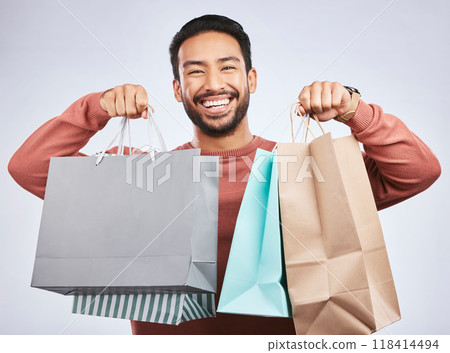 Shopping bag, studio portrait and happy man customer or client with retail product, gift or fashion spree choice. Boutique discount deal, market present and excited person smile on white background Shopping bag, studio portrait and happy man customer or client with retail product, gift or fashion spree choice. Boutique discount deal, market present and excited person smile on white background 118414494