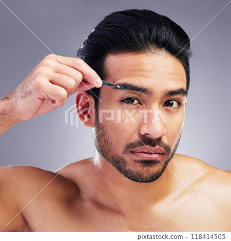Tweezer, eyebrow and portrait of a man in studio for beauty, hygiene or grooming. Facial hair removal, epilation and face of asian person for skincare, self care and cosmetic tools on grey background Tweezer, eyebrow and portrait of a man in studio for beauty, hygiene or grooming. Facial hair removal, epilation and face of asian person for skincare, self care and cosmetic tools on grey background 118414505