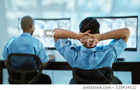Security guard, safety and team in control room with a computer screen for surveillance. Behind a man and woman officer relax in office for crime investigation with cctv monitor and camera footage 118414522