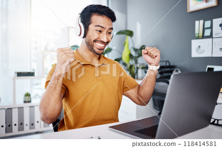 Business man, laptop and headphones to celebrate success while listening to music, audio or video call. Asian male entrepreneur at desk with a smile and hands for achievement, notification or goals Business man, laptop and headphones to celebrate success while listening to music, audio or video call. Asian male entrepreneur at desk with a smile and hands for achievement, notification or goals 118414581
